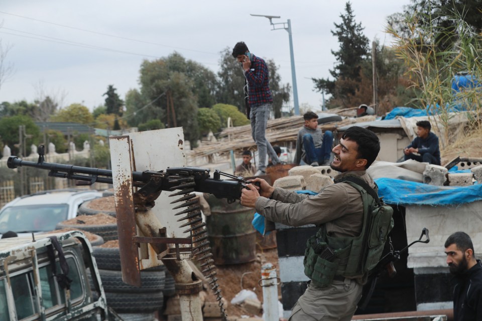 A Kurdish soldier smiles following the collapse of Assad's regime