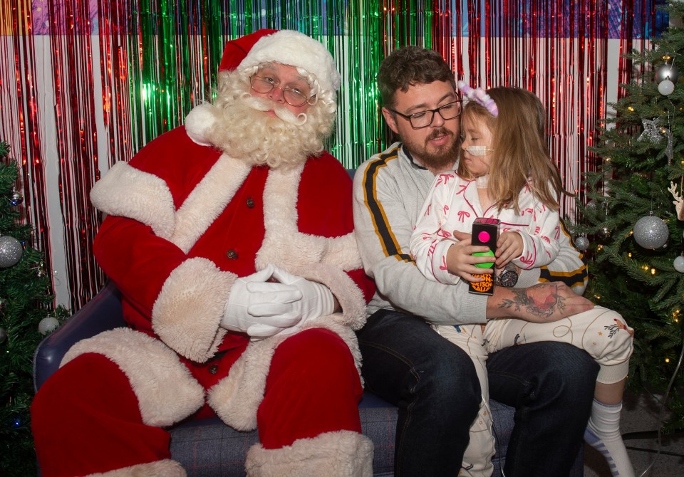 Hallie Mai Formstone with Santa and her father at Birmingham Children's Hospital.