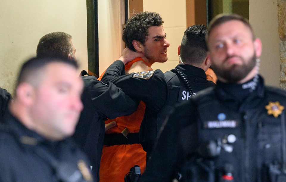 Luigi Mangione is restrained by the neck as he’s led into court in Pennsylvania