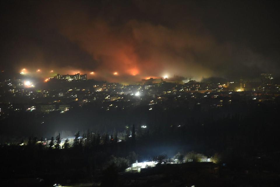 Smoke rises following airstrikes in Damascus on Monday