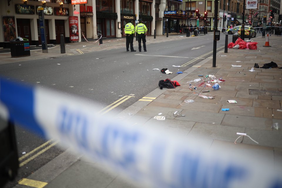 Police officers guard a crime scene in London after a car hit pedestrians.