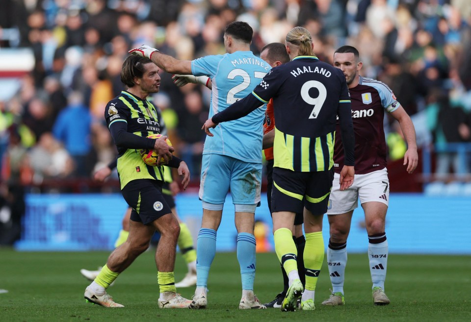 Jack Grealish and Emiliano Martínez arguing with the referee during a soccer match.