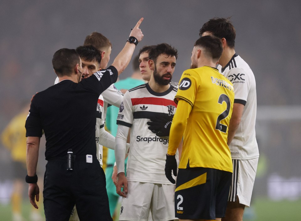 Referee showing Bruno Fernandes a red card.