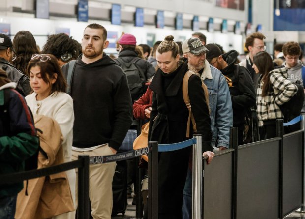 Long line of people checking in for flights at O'Hare International Airport before Thanksgiving.