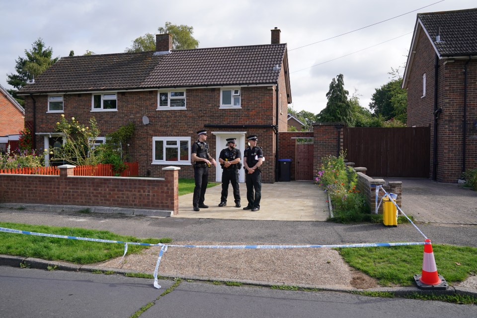 Officers stand in front of the Surrey crime scene where Sara died