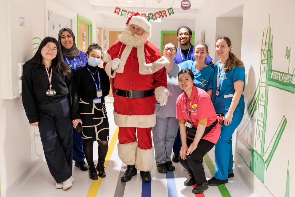 Santa Claus with hospital staff on a children's ward.