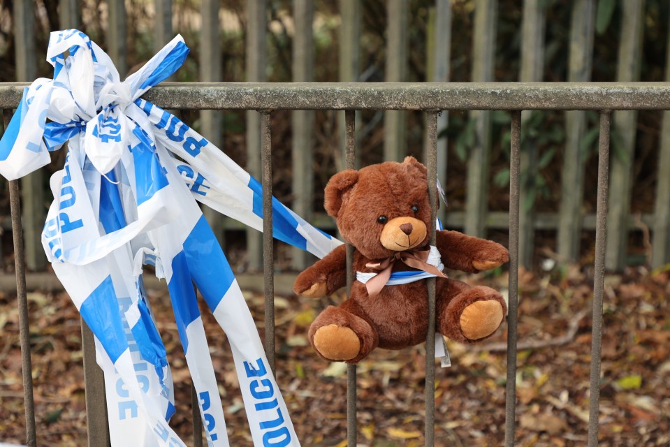 Teddy bear on fence at hit-and-run crash site.