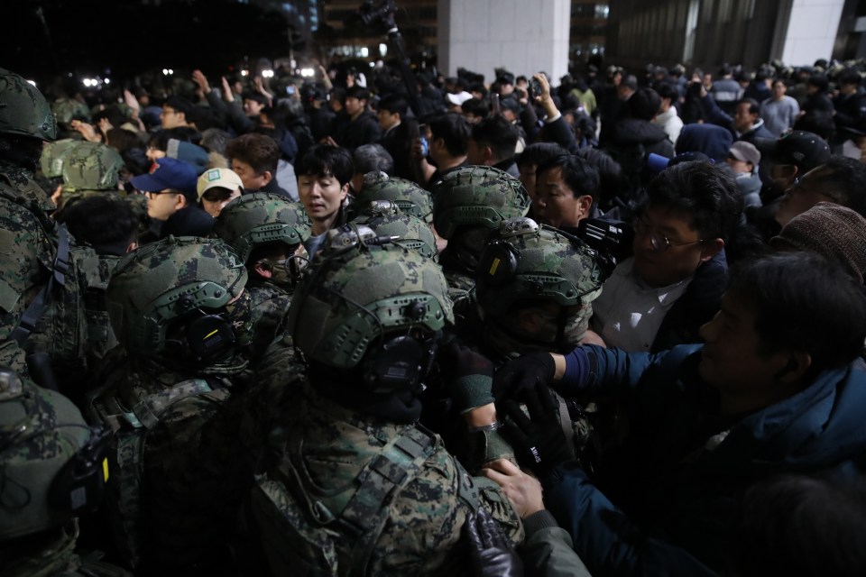 Troops clash with protesters after martial law was declared in South Korea yesterday