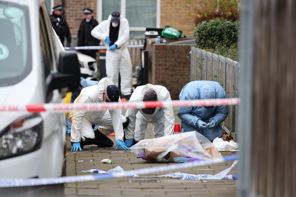 Forensics officers performing a fingertip search