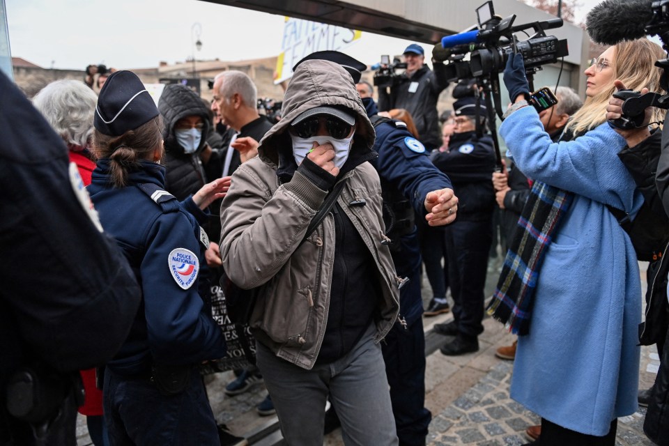 One of the defendants arrives at the courthouse in Avignon this morning