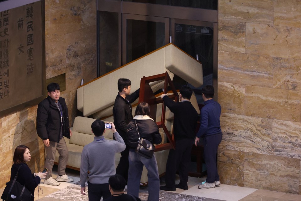 South Korea’s main opposition Democratic Party’s staff set up a barricade to block soldiers at the National Assembly