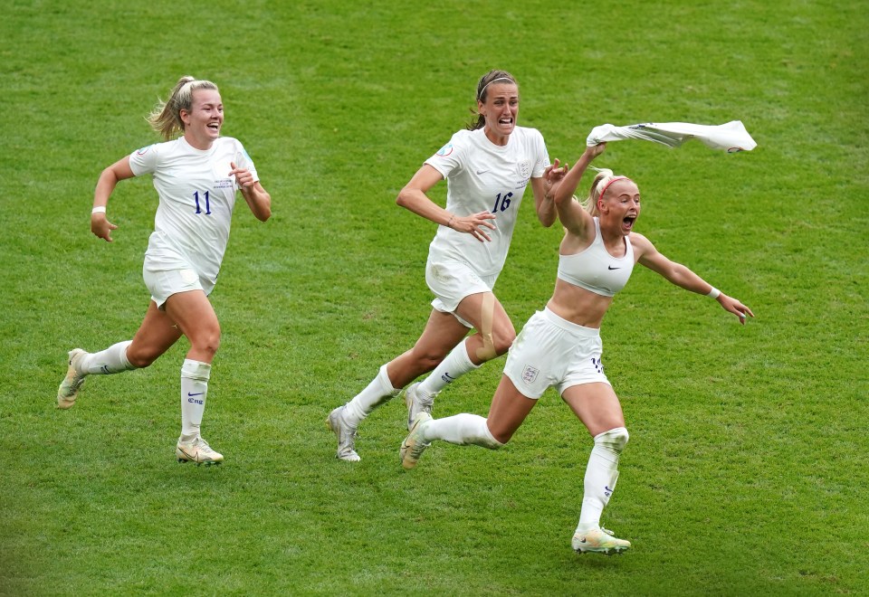 England's women's football team celebrating a goal.