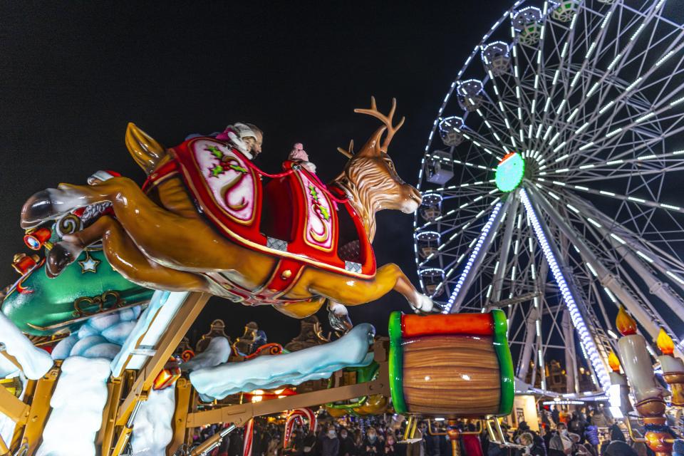 There's a reindeer ride and a traditional big wheel that sits sparkling white in the dark sky