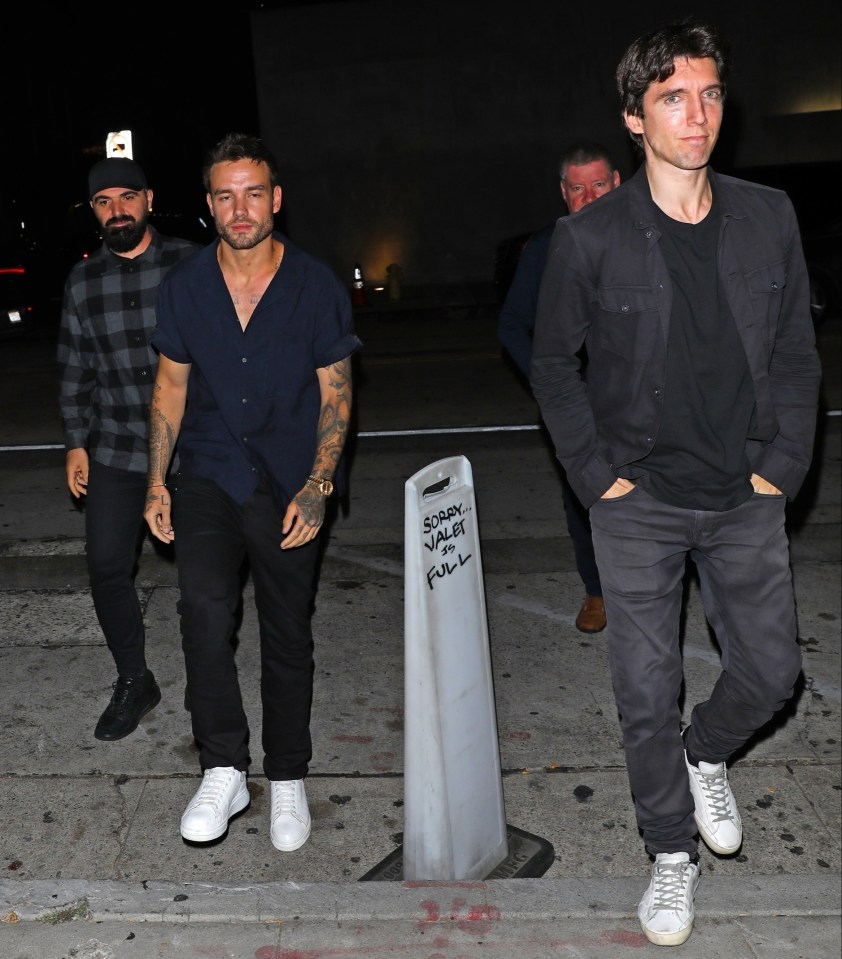 Liam Payne (left) heads out to dinner with friend Roger Nores (right) and his dad Geoff (back right)