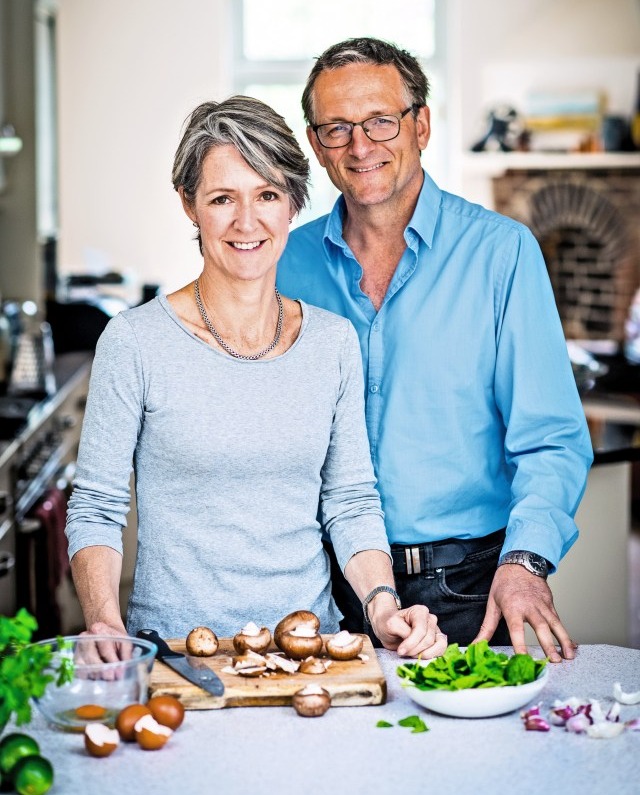 A couple preparing mushrooms in their kitchen.