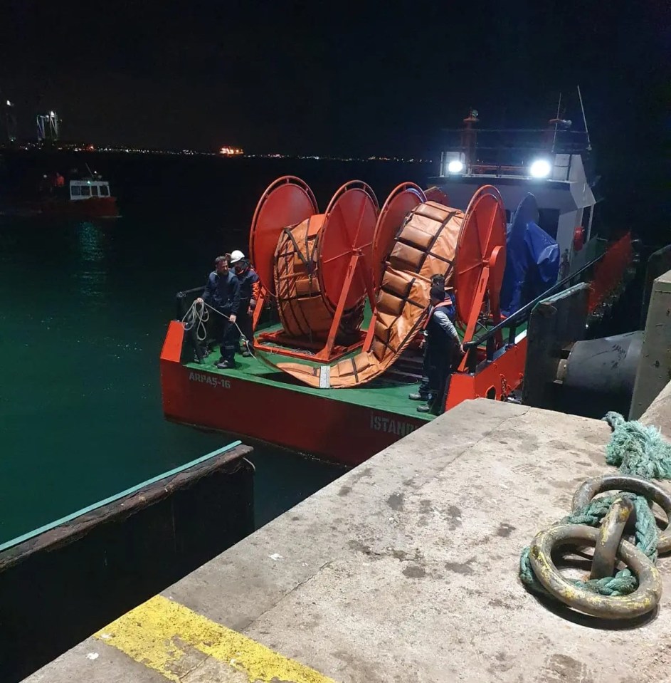 Fifteen crew members evacuated from a capsized cargo ship at night.