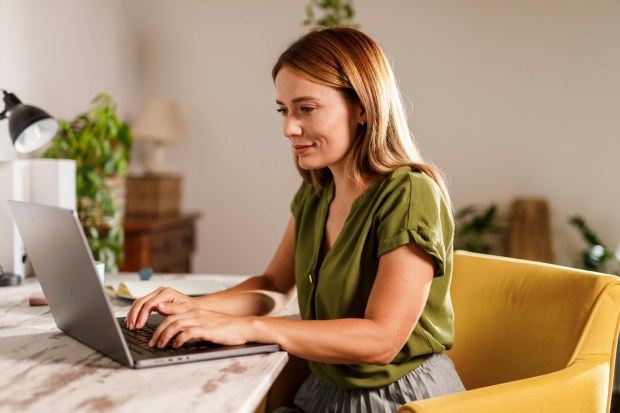 Woman working from home on laptop.