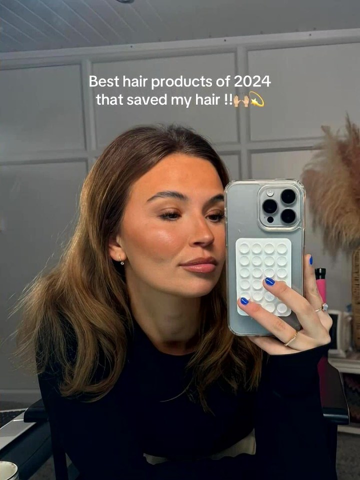 Woman showing off her thick hair after using hair products that helped it grow back.