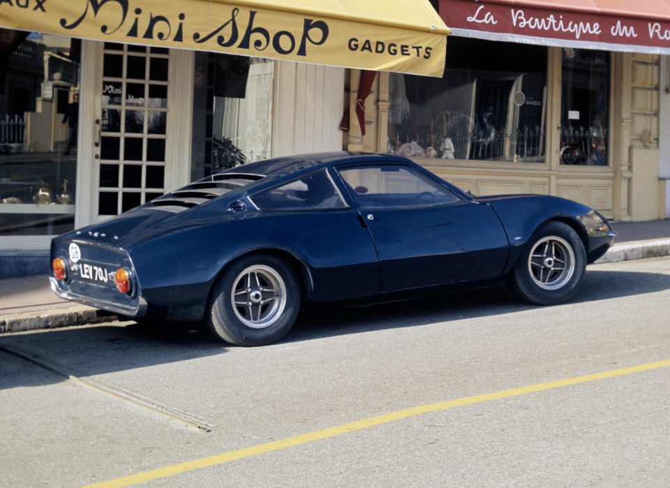 Dark blue Ford GT70 rally car parked on a street in Monte Carlo.