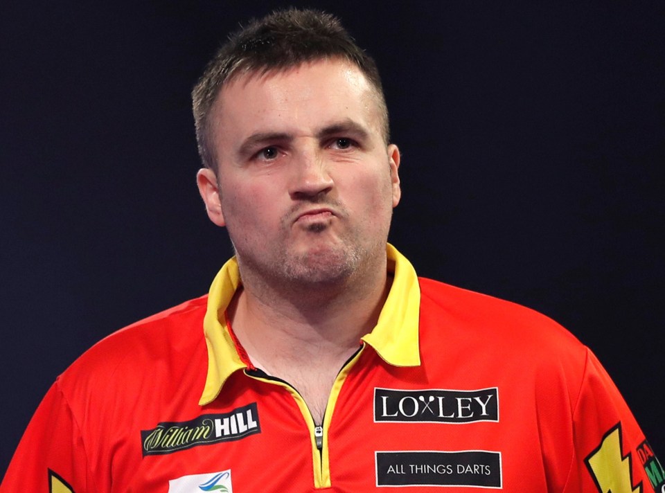 Matthew Edgar of England reacts during a darts match.