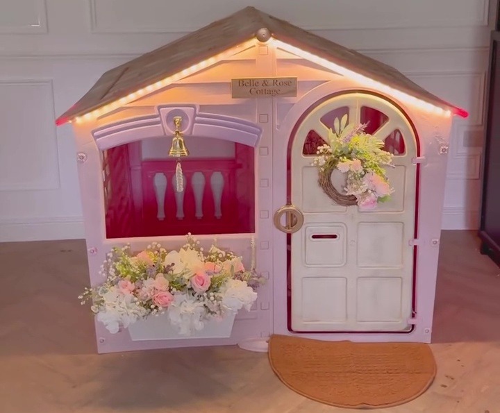 She even attached a window box, fairy lights and a little bell to the cute cottage