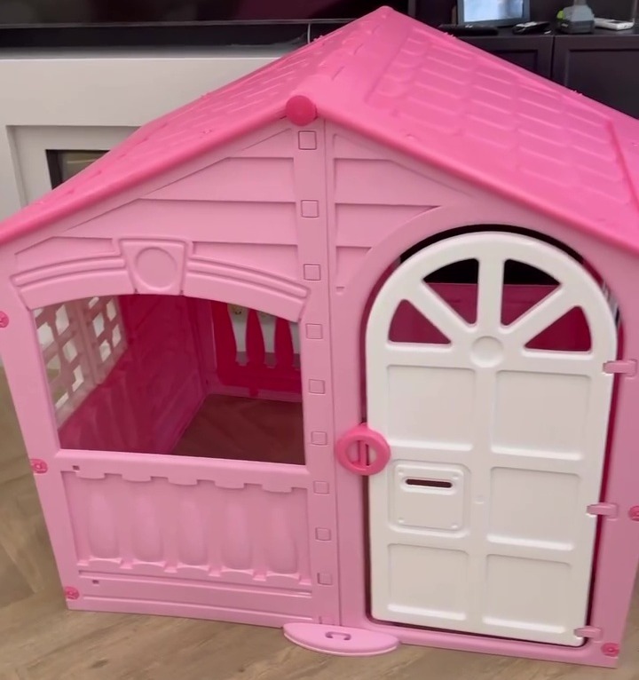 Pink plastic children's playhouse.