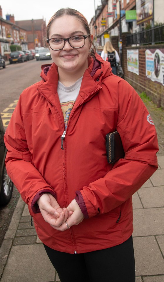 Molly Kelly, a 22-year-old nursery practitioner, standing on a street.