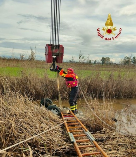 A winch is attached to the car so that it can be lifted out of the water by a crane in southern Italy