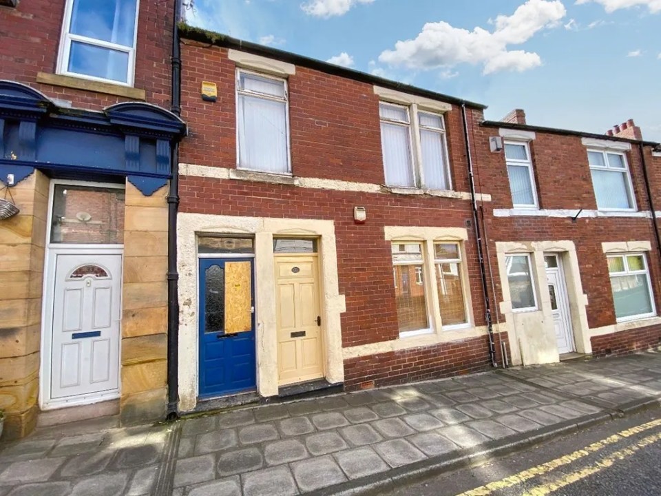 Row of brick terraced houses.