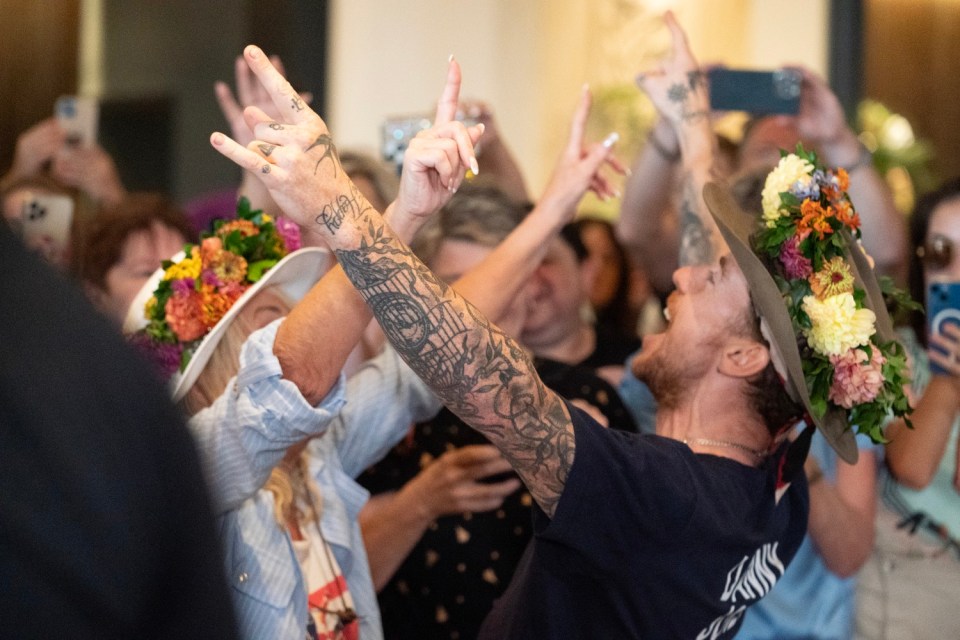 Danny Jones celebrates after I'm A Celebrity still wearing his jungle crown