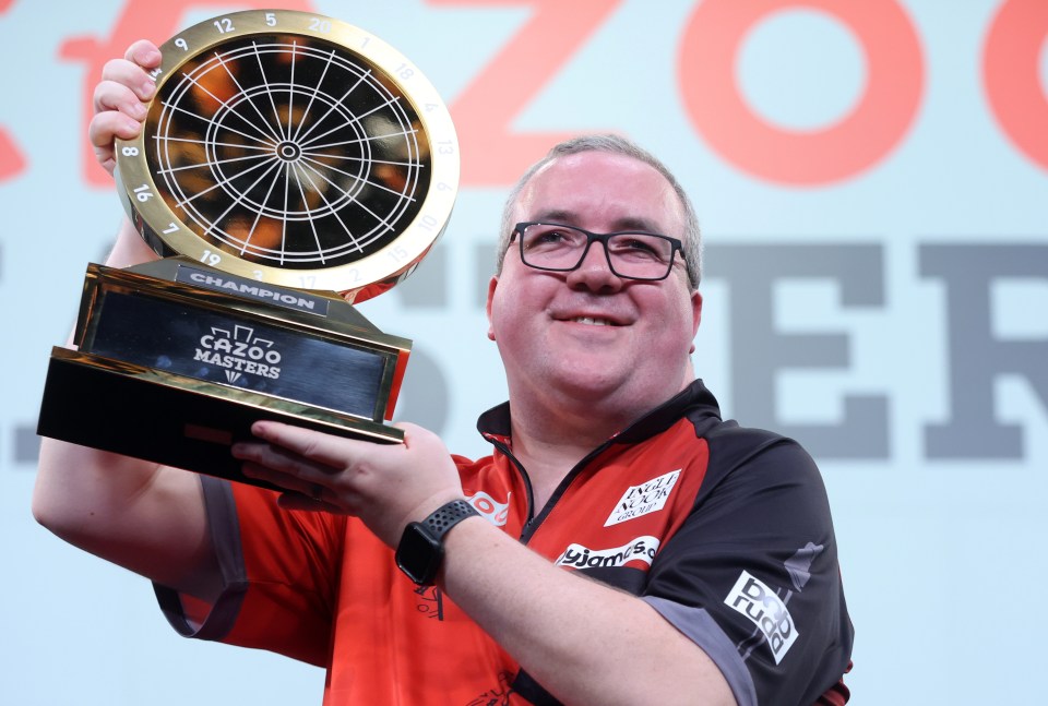 MILTON KEYNES, ENGLAND - FEBRUARY 4: Stephen Bunting with the trophy after winning his PDC 2024 Cazoo Masters Final match against Michael van Gerwen at Marshall Arena on February 4, 2024 in Milton Keynes, England. (Photo by Rob Newell - CameraSport via Getty Images)