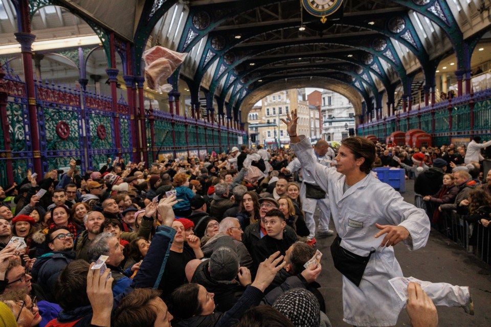 LONDON, ENGLAND - DECEMBER 24: The annual Christmas Eve meat sale at Smithfield Market on December 24, 2024 in London, England. For the past century, the historic Smithfield Market traditionally holds a meat auction on Christmas Eve, where traders sell off their surplus meats. Last month it was announced that Smithfield, the largest wholesale meat market in the UK, would permanently close by 2028, alongside Billingsgate fish market, after the City of London Corporation voted to withdraw support for them. The closure will bring to an end over 800 years of trading meat at the site. (Photo by Dan Kitwood/Getty Images) *** BESTPIX ***