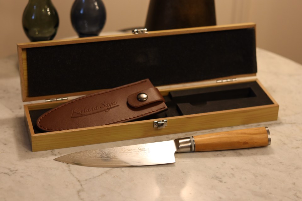 A Katana Saya knife in its wooden box with leather sheath.