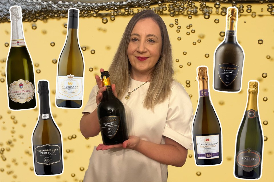 Woman holding a bottle of prosecco with several other bottles displayed.