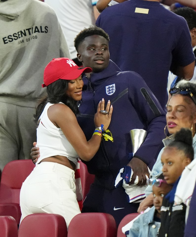 Bukayo Saka with Tolami Benson at a soccer match.