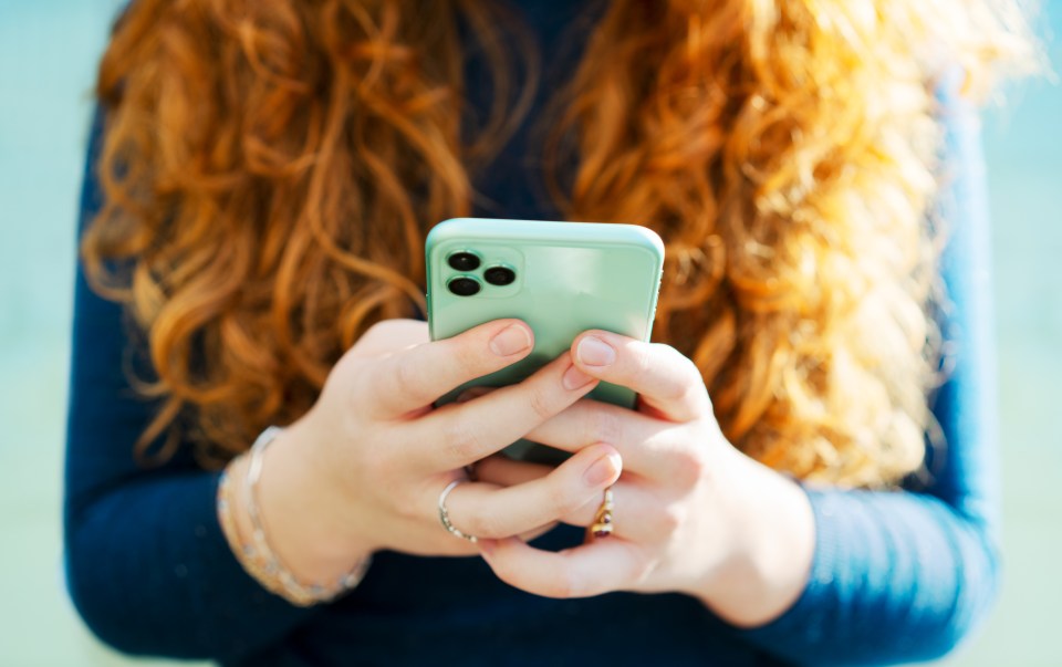 Woman using a smartphone outdoors.