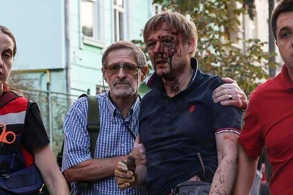 The grieving Yaroslav Bazylevych emerged from the bomb site covered in blood