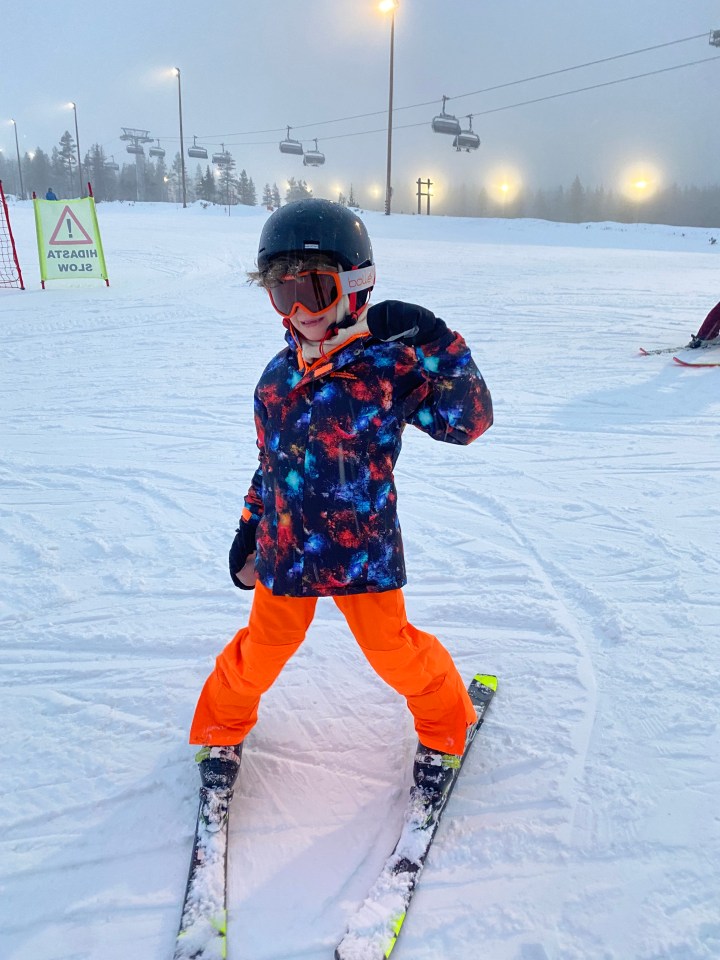 Child skier on a snowy slope in Lapland.