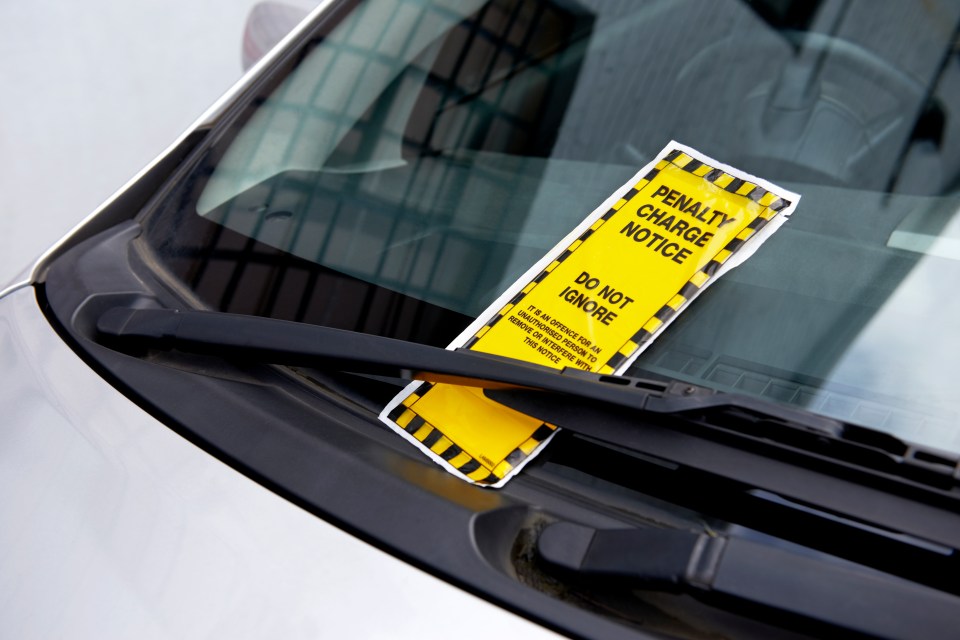 Parking ticket on a car windshield.