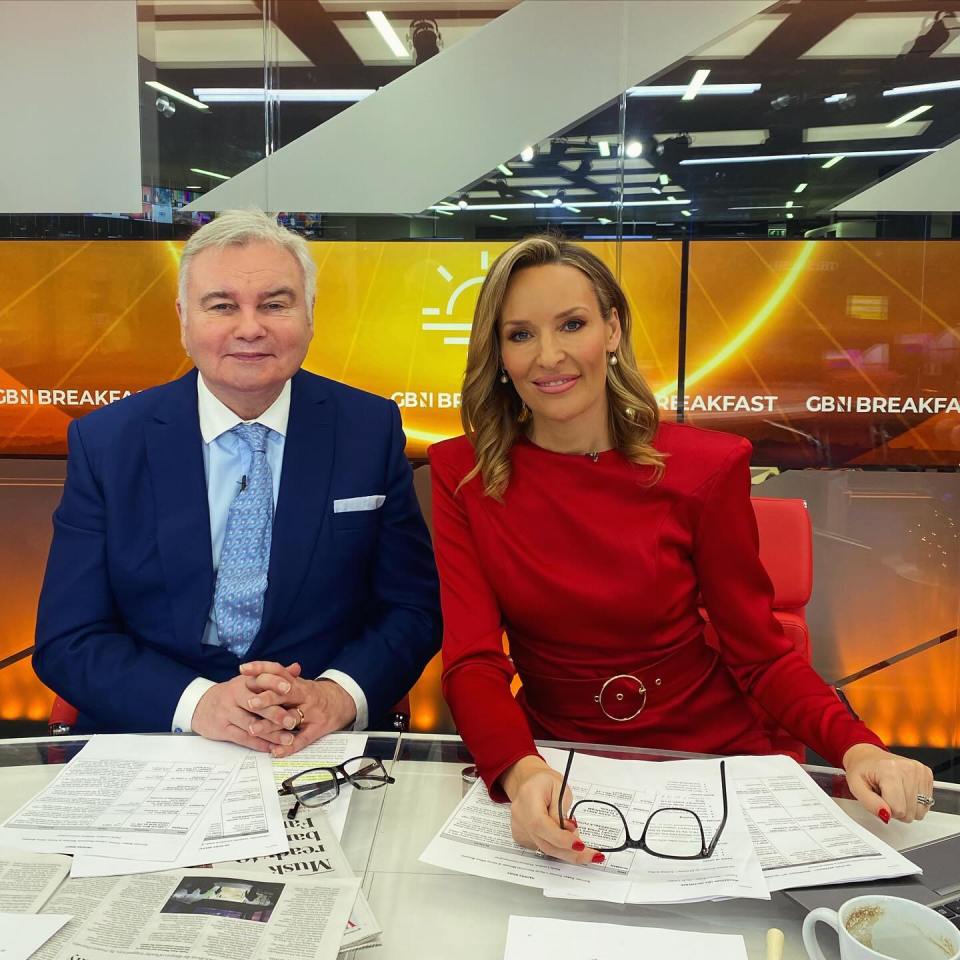 Two news anchors sitting at a desk in a news studio.