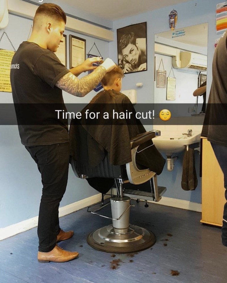 A barber giving a boy a haircut.