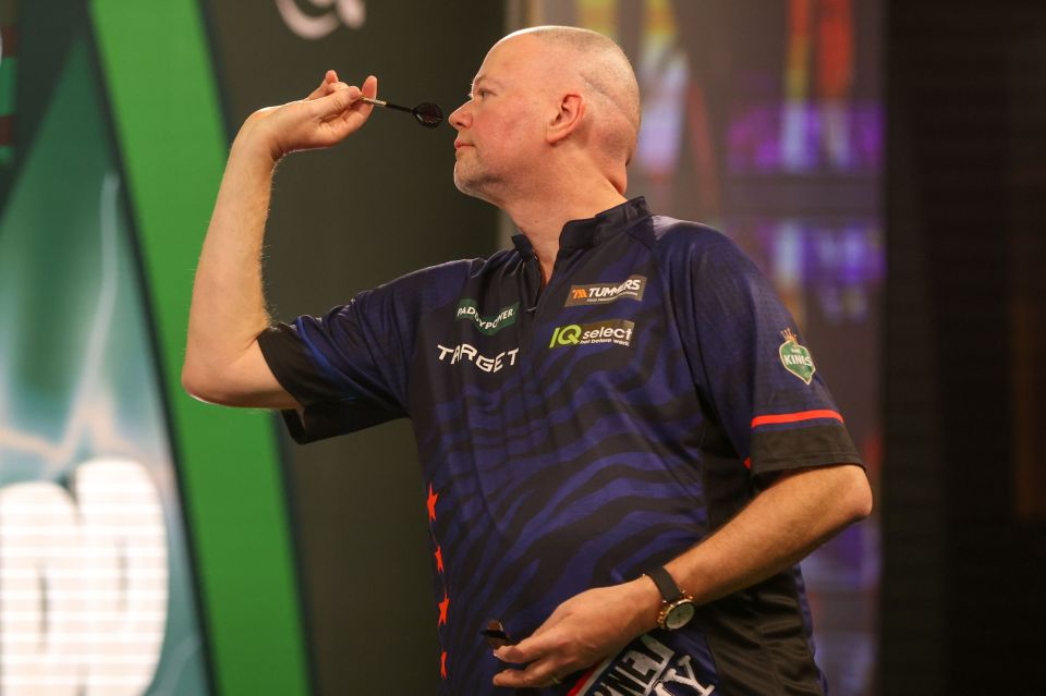 Raymond van Barneveld throwing a dart at the 2024 World Darts Championship.