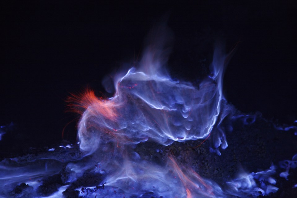 The blue flames erupt from the volcano