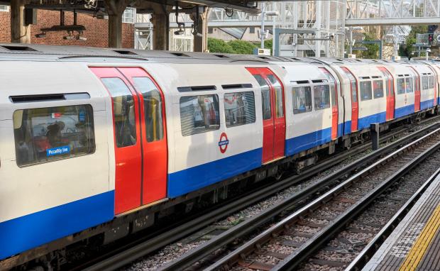 Piccadilly Line London Underground train arriving at a station.