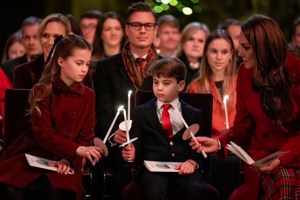 Fans have been in a stir about a 'mystery man' sat behind Prince Louis at Friday's Christmas concert