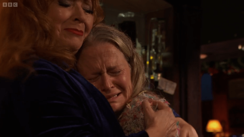 Two women embracing and crying.