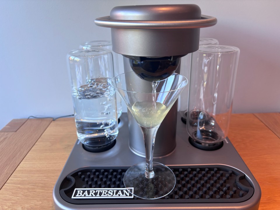 Bartesian cocktail maker dispensing a drink.