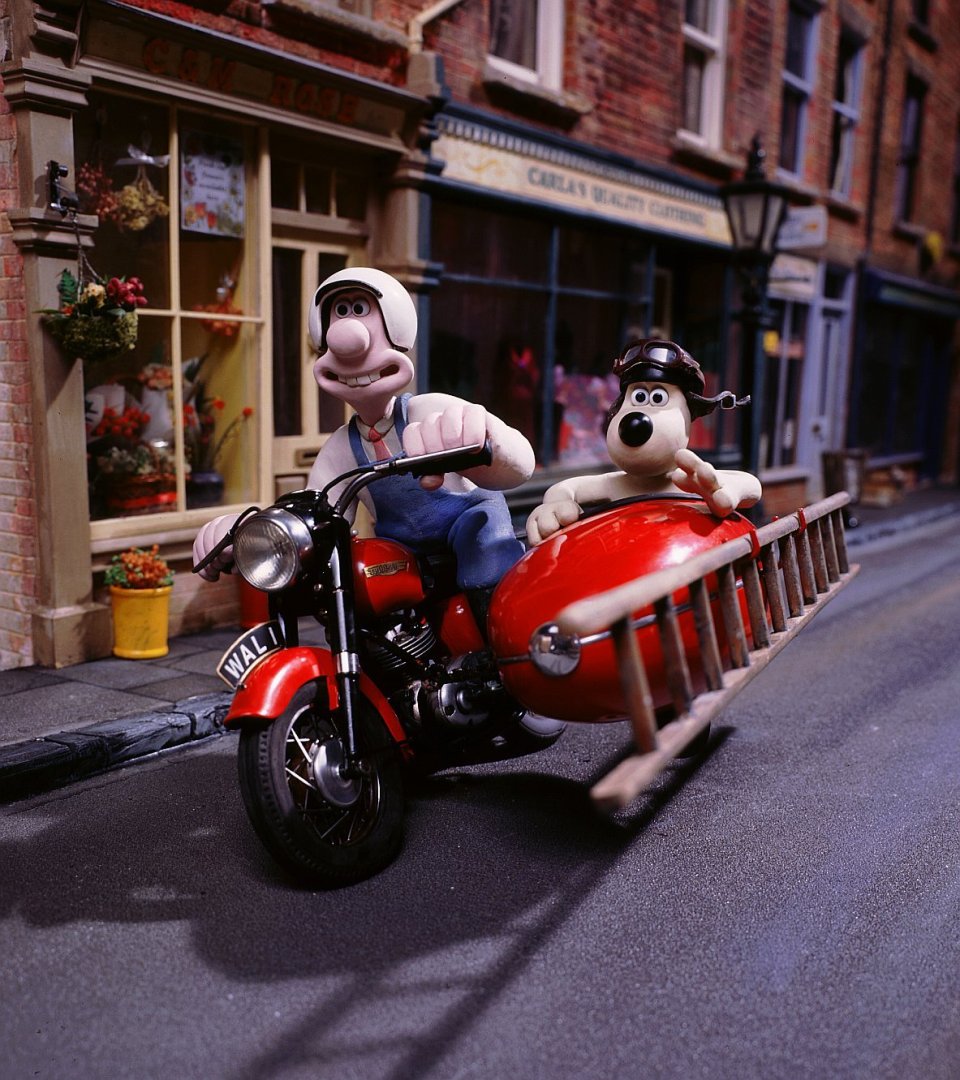 Wallace and Gromit on a motorcycle with sidecar and ladder.