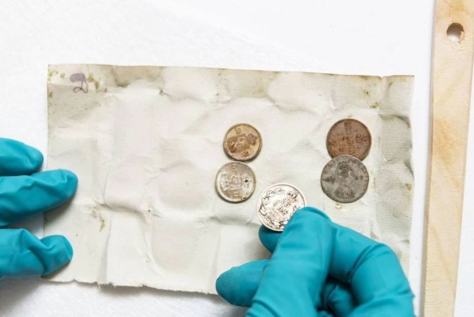 Coins from 1874 were buried with the bottle