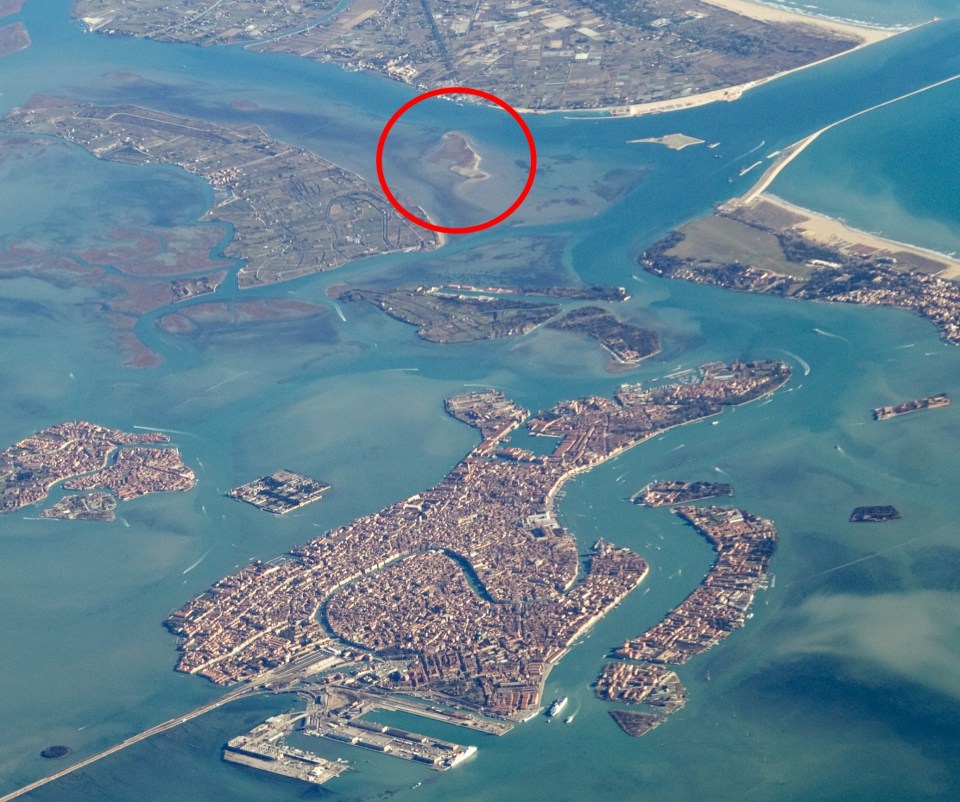 Aerial view of Venice, Italy, with a small island highlighted.